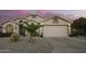 Charming single-story home boasts a well-maintained front yard with desert landscaping and a two-car garage at 18001 N 44Th Way, Phoenix, AZ 85032