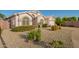 Charming single-story home boasts a well-maintained front yard with desert landscaping and a two-car garage at 18001 N 44Th Way, Phoenix, AZ 85032