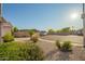 Charming front yard featuring desert landscaping, lush greenery, and a view of the home's driveway at 18001 N 44Th Way, Phoenix, AZ 85032