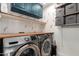 Well-equipped laundry room featuring a wooden countertop, shelving, and overhead storage at 18001 N 44Th Way, Phoenix, AZ 85032
