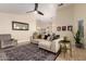 Inviting living room with a comfortable sofa, accent pillows, a patterned rug, and open access to the kitchen at 18001 N 44Th Way, Phoenix, AZ 85032