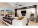 Stylish living room with a decorative wall, large windows, comfortable seating and bright natural light at 18001 N 44Th Way, Phoenix, AZ 85032