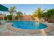 Beautiful backyard swimming pool with stone waterfall feature at 18001 N 44Th Way, Phoenix, AZ 85032