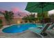 Relax in style by the sparkling pool, complete with a shaded umbrella and comfortable lounge chairs at 18001 N 44Th Way, Phoenix, AZ 85032