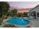 Enjoy a private backyard oasis featuring a sparkling pool, lush landscaping, and comfortable lounge chairs at 18001 N 44Th Way, Phoenix, AZ 85032