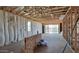 Spacious unfinished room with exposed framing and sliding glass doors to the exterior at 18271 W La Senda Dr, Surprise, AZ 85387