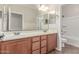 Bathroom featuring a double vanity with matching mirrors and a separate shower/tub area with a toilet at 1843 S Sunnyvale Ave, Gilbert, AZ 85295