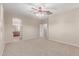 Bedroom featuring neutral carpet, ceiling fan, and a doorway to bathroom at 1843 S Sunnyvale Ave, Gilbert, AZ 85295