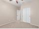 Bedroom with neutral walls, carpet, ceiling fan, closet with sliding doors, and door to another room at 1843 S Sunnyvale Ave, Gilbert, AZ 85295