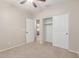 Bedroom with neutral walls, carpet, ceiling fan, closet with sliding doors, and door to another room at 1843 S Sunnyvale Ave, Gilbert, AZ 85295