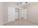 Bedroom with neutral walls, carpet, ceiling fan, closet with sliding doors, and door to another room at 1843 S Sunnyvale Ave, Gilbert, AZ 85295
