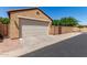 Attached two-car garage with a driveway and desert landscaping at 1843 S Sunnyvale Ave, Gilbert, AZ 85295