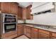 Modern kitchen showcasing the built in oven, range hood and gas cooktop at 1843 S Sunnyvale Ave, Gilbert, AZ 85295