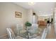 Dining area with glass table, seating for four, and open view into the kitchen at 19005 N Diamante Dr, Surprise, AZ 85387