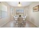 Bright dining area features a glass table, four chairs, and lots of natural light at 19005 N Diamante Dr, Surprise, AZ 85387