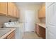 Functional laundry room with washer, dryer, extra storage, and ample counter space for folding at 19005 N Diamante Dr, Surprise, AZ 85387