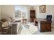 Home office with large window, desk, sofa, and natural light at 19005 N Diamante Dr, Surprise, AZ 85387