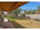 Large backyard has a covered patio with seating and a spacious lawn at 20627 W Grandview Dr, Buckeye, AZ 85396