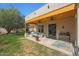 Inviting covered patio with ceiling fans and comfortable seating, overlooking the yard at 20627 W Grandview Dr, Buckeye, AZ 85396