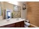Bathroom with dual sinks, wooden accents, decorative birdcage and patterned wallpaper and shower curtain at 20627 W Grandview Dr, Buckeye, AZ 85396