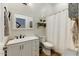 Bright bathroom features a double sink vanity, wood-look tile floors, and a shower-tub combo at 20627 W Grandview Dr, Buckeye, AZ 85396