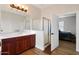 Well-lit bathroom with a shower, wood floors, and vanity with plenty of natural light at 20627 W Grandview Dr, Buckeye, AZ 85396