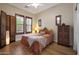 Cozy bedroom featuring a bed, windows, and hardwood floors with unique decorations at 20627 W Grandview Dr, Buckeye, AZ 85396