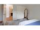 Cozy bedroom with closet, carpeted floors, open bathroom, and a wooden framed mirror at 20627 W Grandview Dr, Buckeye, AZ 85396