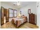 Warm bedroom featuring wood-look floors, natural lighting, and a comfortable bed at 20627 W Grandview Dr, Buckeye, AZ 85396