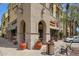 Commercial building with stone archways, outdoor seating, and a street-side bench and trash can at 20627 W Grandview Dr, Buckeye, AZ 85396