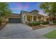 Charming home featuring a welcoming front porch, stone accents, and manicured landscaping at 20627 W Grandview Dr, Buckeye, AZ 85396