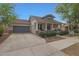 Charming home with a front-facing two car garage and well-kept lawn and landscaping at 20627 W Grandview Dr, Buckeye, AZ 85396