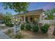 Charming home featuring a welcoming front porch, stone accents, and manicured landscaping at 20627 W Grandview Dr, Buckeye, AZ 85396