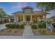 Charming home featuring a welcoming front porch, stone accents, and manicured landscaping at 20627 W Grandview Dr, Buckeye, AZ 85396