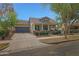 Beautiful single Gathering home showcasing a two-car garage and a covered front porch at 20627 W Grandview Dr, Buckeye, AZ 85396