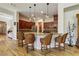 Modern kitchen with barstool seating, granite counters, hardwood floors, and pendant lighting at 20627 W Grandview Dr, Buckeye, AZ 85396