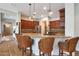 Modern kitchen features granite countertops, an island with seating, and wood cabinets at 20627 W Grandview Dr, Buckeye, AZ 85396