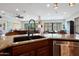 Kitchen island features a sink, stainless steel dishwasher, and views of the dining and living areas at 20627 W Grandview Dr, Buckeye, AZ 85396