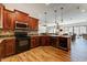 Well-appointed kitchen features wooden cabinets, stainless steel appliances, and hardwood floors at 20627 W Grandview Dr, Buckeye, AZ 85396