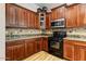 Gourmet kitchen with wooden cabinets, granite countertops, and a tile backsplash at 20627 W Grandview Dr, Buckeye, AZ 85396