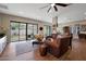 Inviting living room with wood floors, leather sofa, and backyard access at 20627 W Grandview Dr, Buckeye, AZ 85396