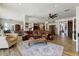 Spacious living room with wood floors, comfortable leather furniture, and a decorative rug at 20627 W Grandview Dr, Buckeye, AZ 85396