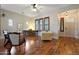 Bright living room featuring hardwood floors, warm lighting, and large windows, perfect for relaxation and entertaining at 20627 W Grandview Dr, Buckeye, AZ 85396