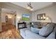 Spacious living room with a comfortable sectional, hardwood floors, and modern lighting, ideal for relaxation and entertainment at 20627 W Grandview Dr, Buckeye, AZ 85396
