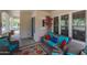 Cozy porch with comfortable seating, a vibrant rug, and views of the front yard at 20627 W Grandview Dr, Buckeye, AZ 85396