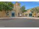 View of the El Dorado Elementary School building with blue doors and windows, manicured landscaping, and street access at 20627 W Grandview Dr, Buckeye, AZ 85396