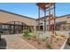 Stylish shopping center featuring a rooster and fox sculpture, desert landscaping, and contemporary architecture at 20627 W Grandview Dr, Buckeye, AZ 85396