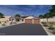 Beautiful home featuring a stone-accented facade, a two-car garage, and desert landscaping at 21347 W Jojoba Ct, Buckeye, AZ 85396