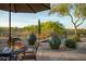 Backyard patio featuring a table with charcuterie board, wine and desert landscaping at 23014 N 52Nd St, Phoenix, AZ 85054