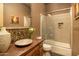 Contemporary bathroom showcasing a uniquely shaped vessel sink, framed mirror, and tiled shower/tub combo at 23014 N 52Nd St, Phoenix, AZ 85054